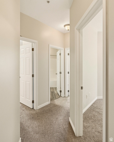 1177 Northfield Road, Unit 26 Cedar City, UT 84721 - Photo 20 of 45 Hallway featuring neutral carpet, light neutral wall paint, and white trim