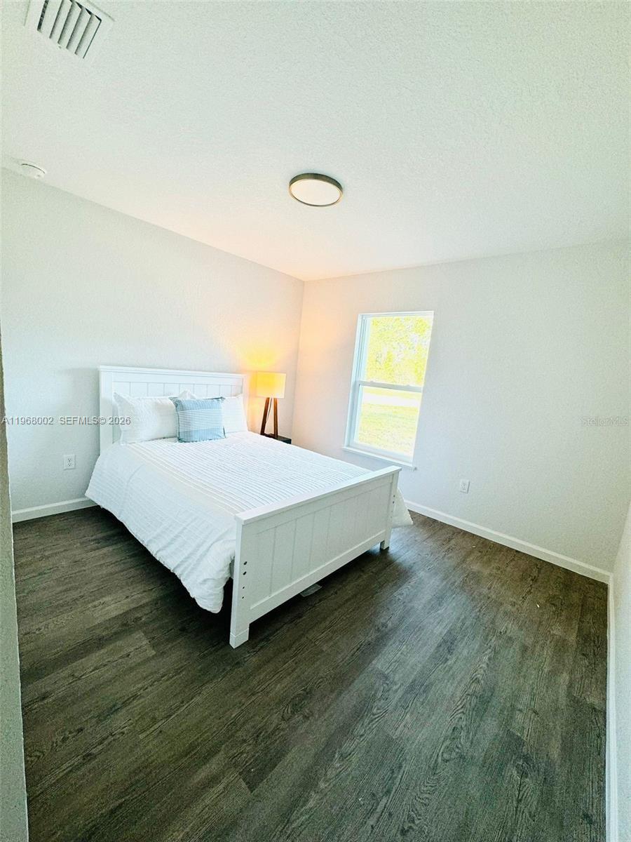 13731 Southwest 89 Circle Ocala, FL 34473 - Photo 15 of 24 a large bed sitting in a room next to a window