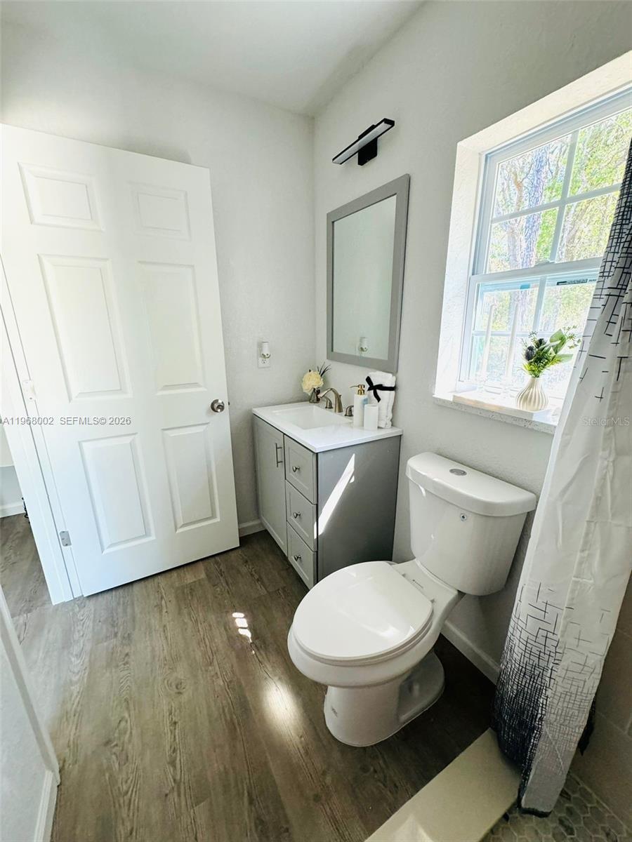 13731 Southwest 89 Circle Ocala, FL 34473 - Photo 22 of 24 a white toilet sitting next to a bathroom sink