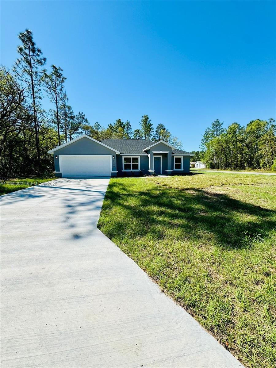 13731 Southwest 89 Circle Ocala, FL 34473 - Photo 3 of 24 a front view of a house with a yard