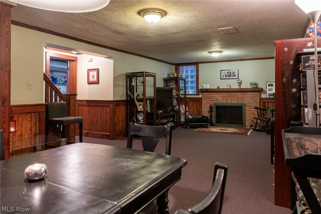 3433 Bradford Road Cleveland, OH 44118 - Photo 26 of 35 The lower level provides a Finished Rec rm w/ rich wd paneling & trim & is complimented by the neutral toned walls & carpeting. The wd burning FP & all glass block windows add warmth & comfort to the Lg living space for entertaining or relaxing.