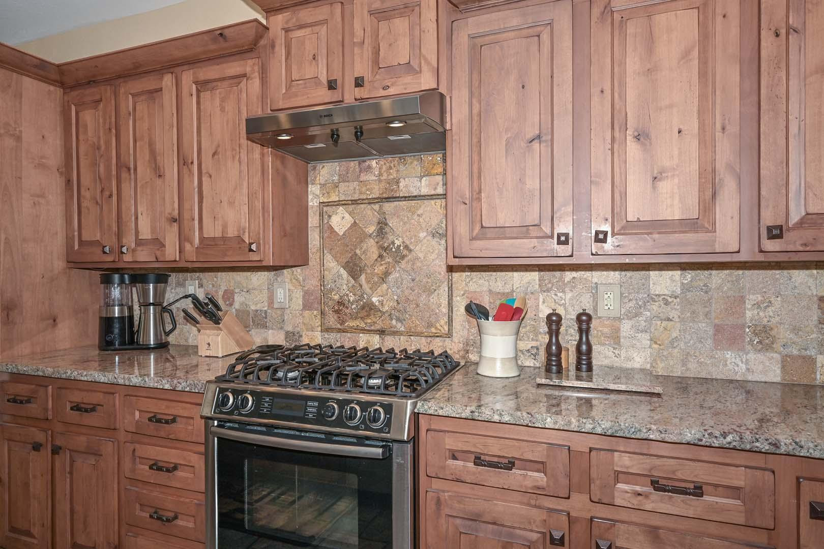 41418 North Clear Crossing Road Anthem, AZ 85086 - Photo 18 of 43 a kitchen with stainless steel appliances granite countertop white cabinets and a stove top oven