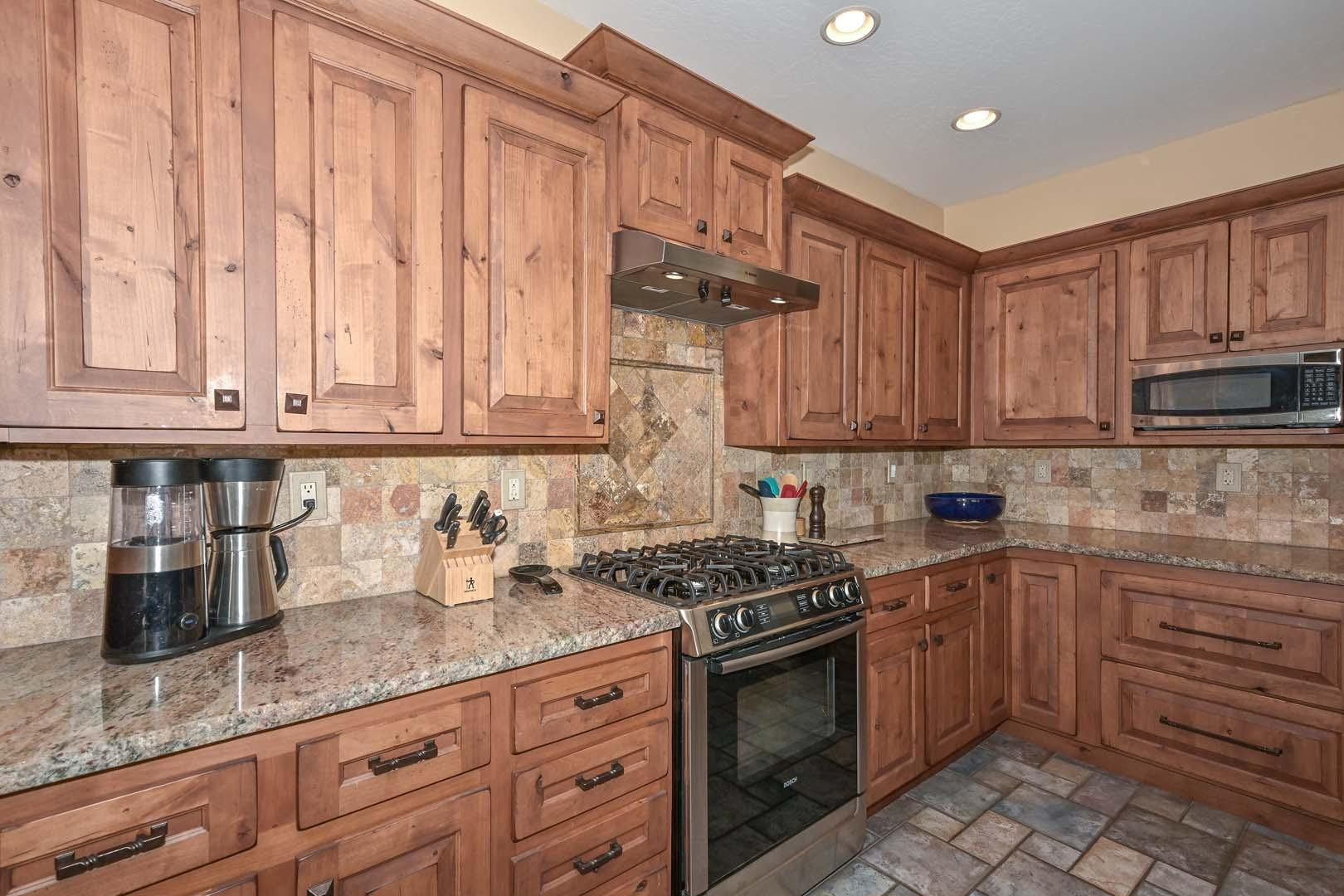 41418 North Clear Crossing Road Anthem, AZ 85086 - Photo 21 of 43 a kitchen with granite countertop a stove sink and cabinets