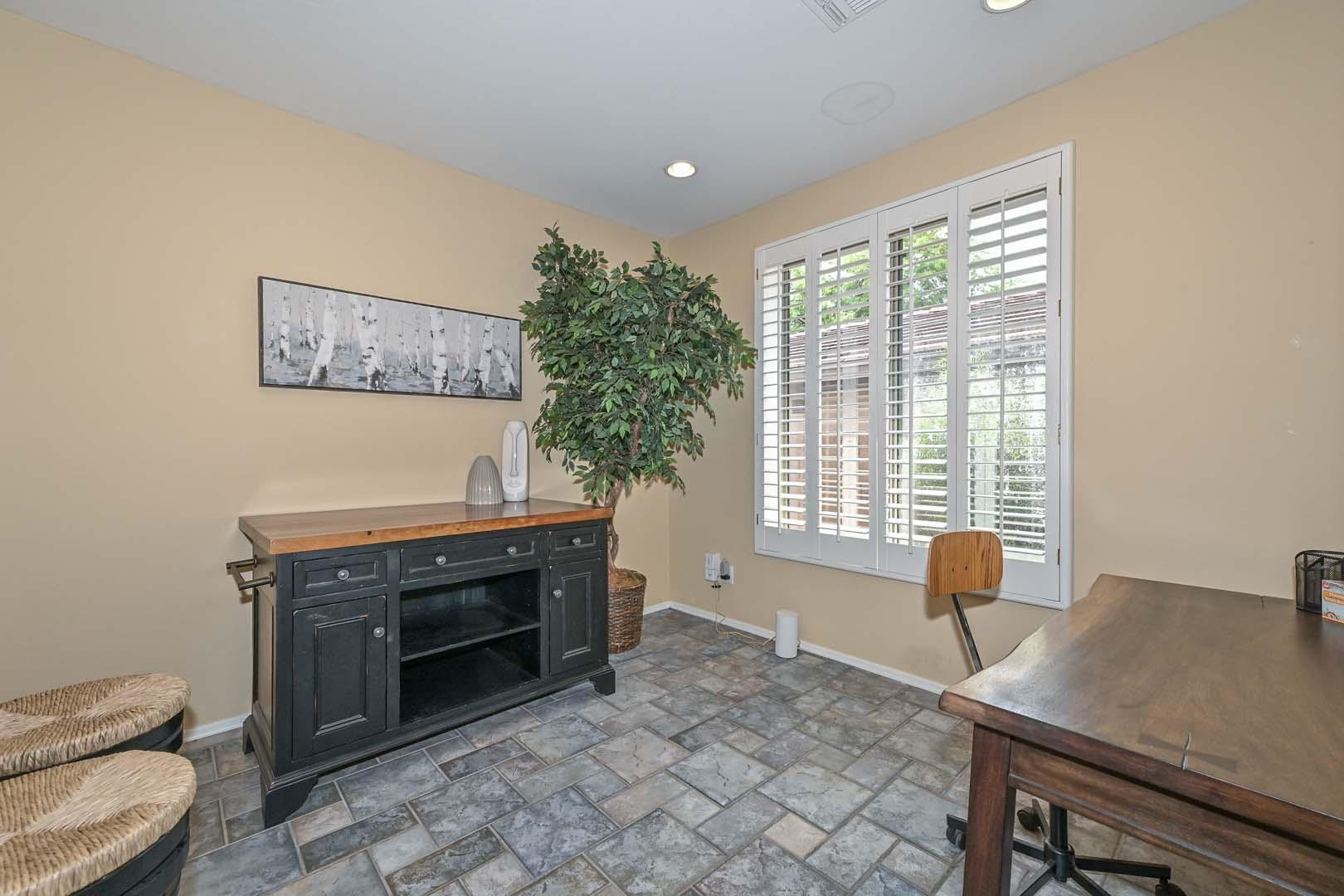 41418 North Clear Crossing Road Anthem, AZ 85086 - Photo 24 of 43 a living room with furniture a window and a fireplace