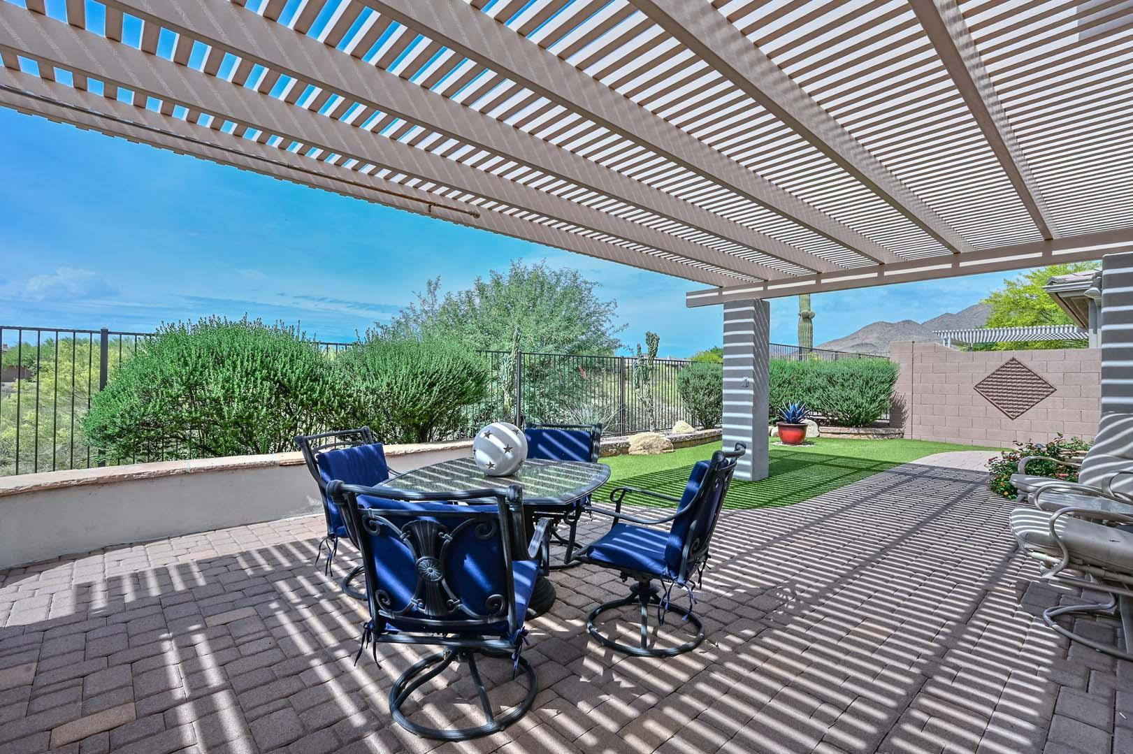 41418 North Clear Crossing Road Anthem, AZ 85086 - Photo 3 of 43 a view of a patio with table and chairs under an umbrella