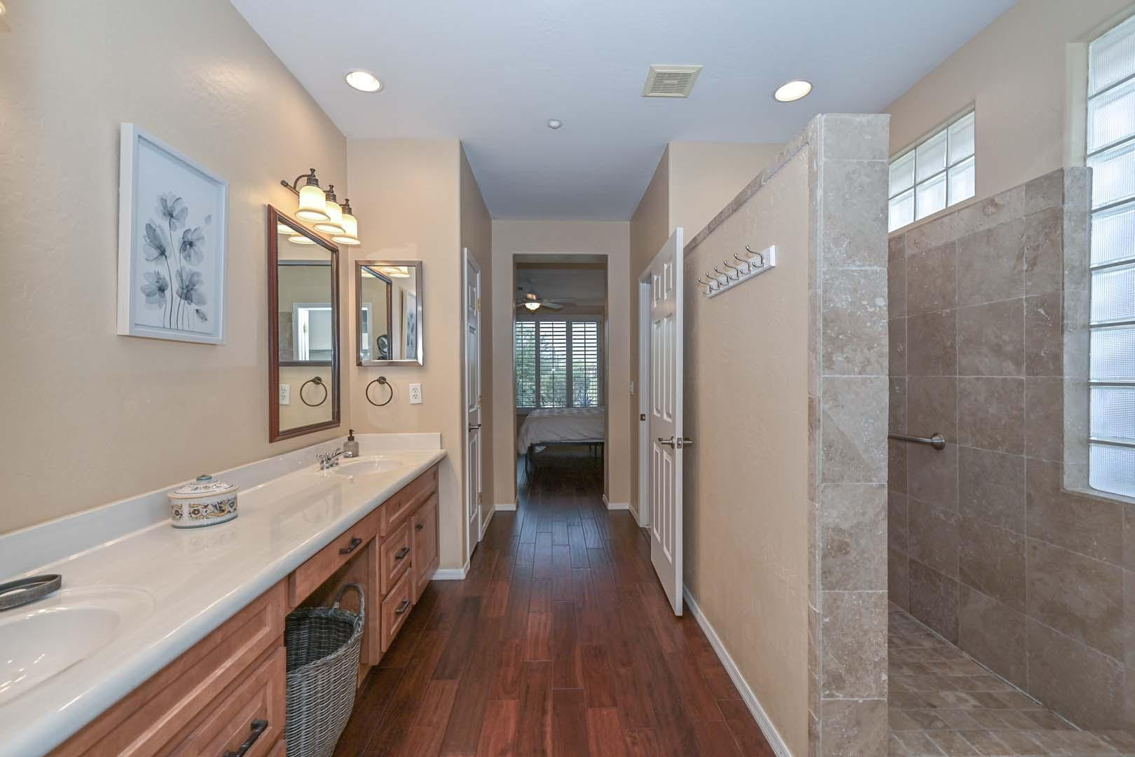 41418 North Clear Crossing Road Anthem, AZ 85086 - Photo 33 of 43 a spacious bathroom with a double vanity sink a mirror and a shower