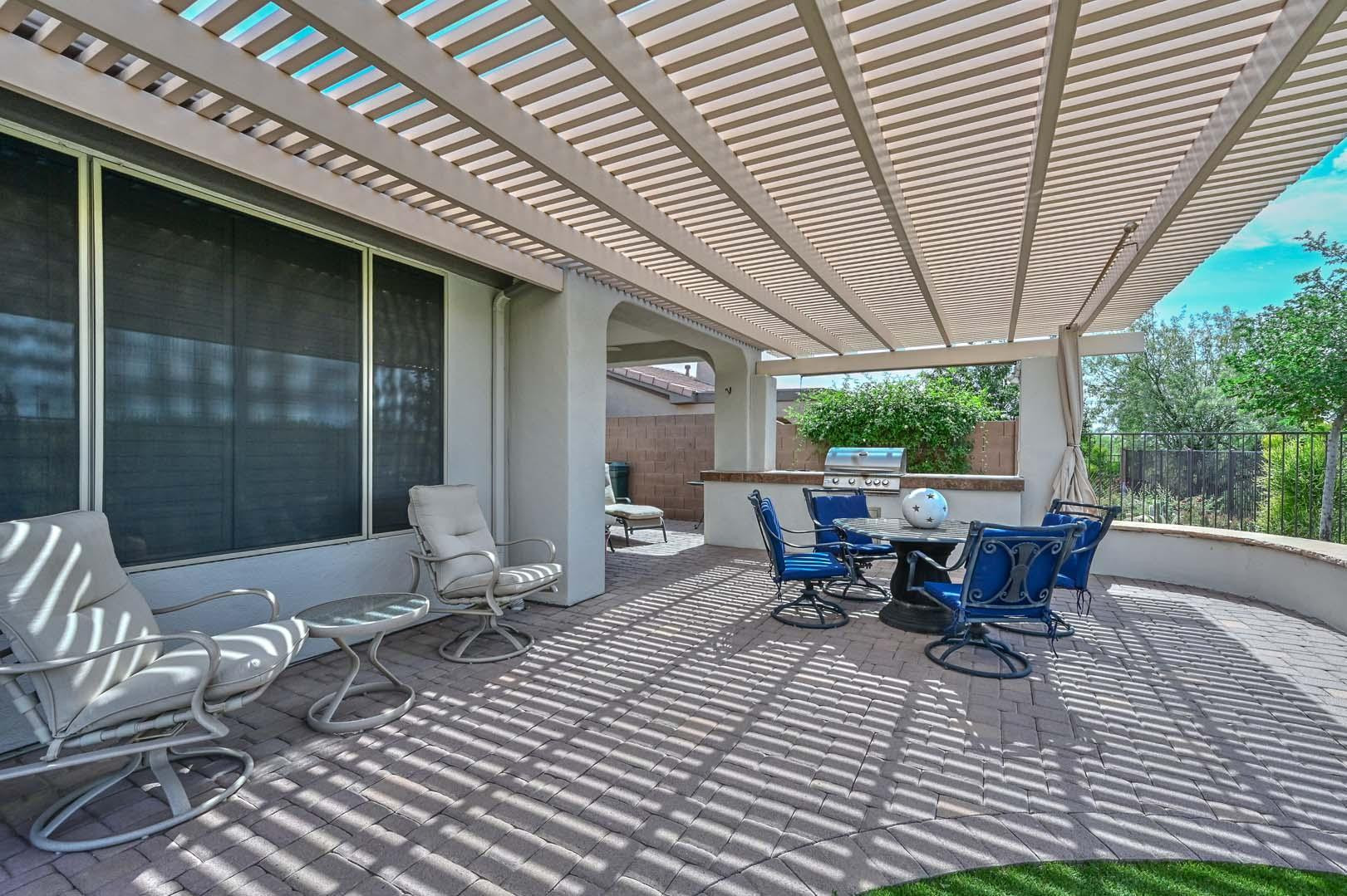 41418 North Clear Crossing Road Anthem, AZ 85086 - Photo 35 of 43 a view of a patio with table and chairs potted plants with wooden floor and fence