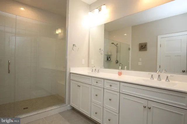 a bedroom with a large bed couch tv and a window