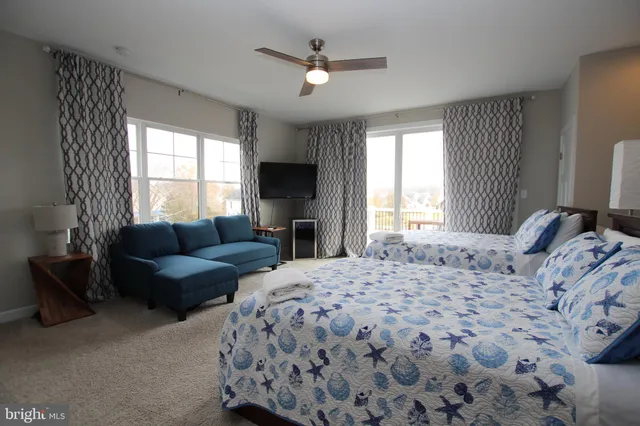 a spacious bedroom with a bed couch and window