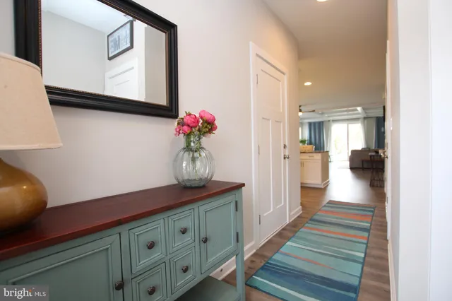a view of entryway with furniture and wooden floor