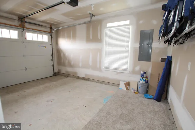a living room with furniture a flat screen tv and a window
