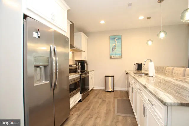 a kitchen with a refrigerator and a sink