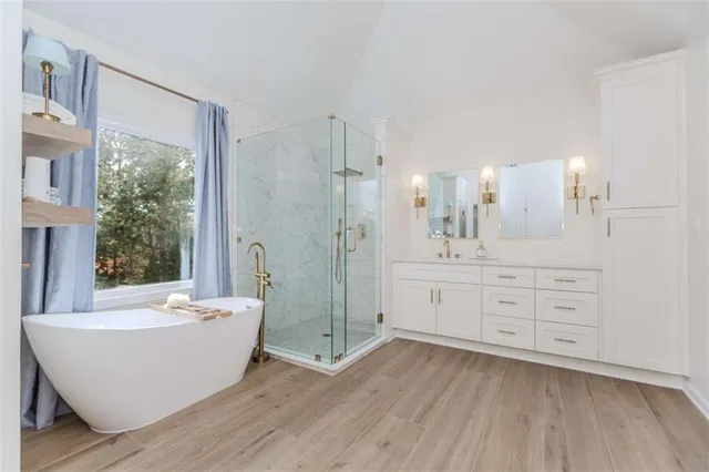 a spacious bathroom with a large tub shower and sink