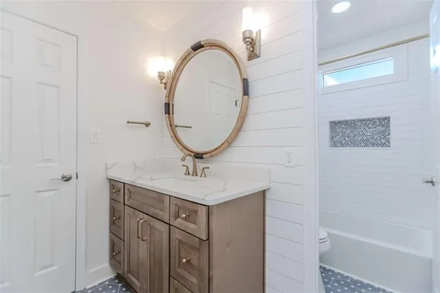 a bathroom with a sink a mirror and a shower