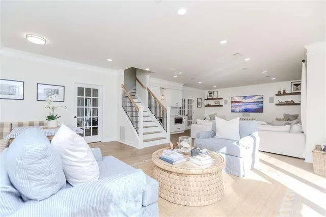 a living room with furniture and a dining table with kitchen view