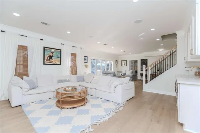 a spacious bedroom with a bed a couch and a view of living room