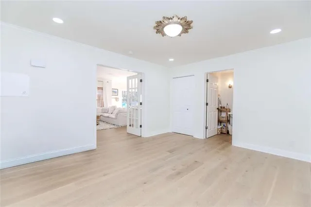 an empty room with cabinet and wooden floor