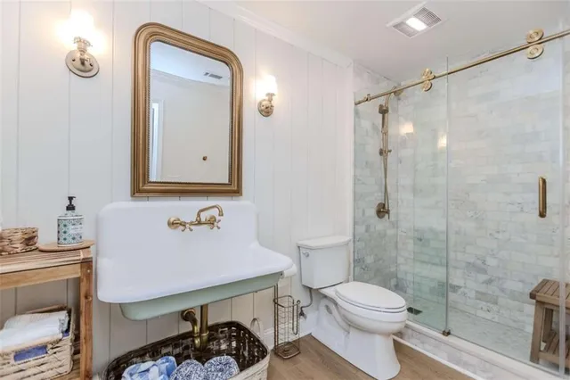 a bathroom with a sink toilet and shower