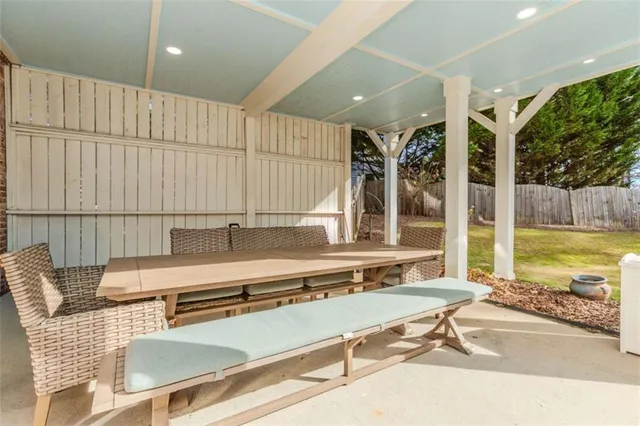 a living room with a floor to ceiling window and pool table