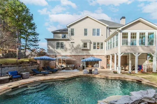 a front view of a house with swimming pool and a yard