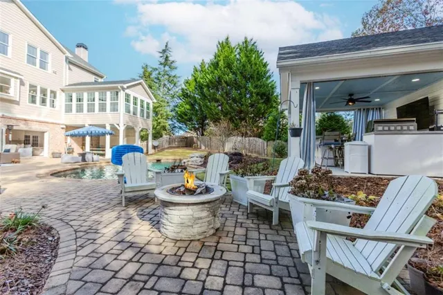 a view of a patio with table and chairs and potted plants