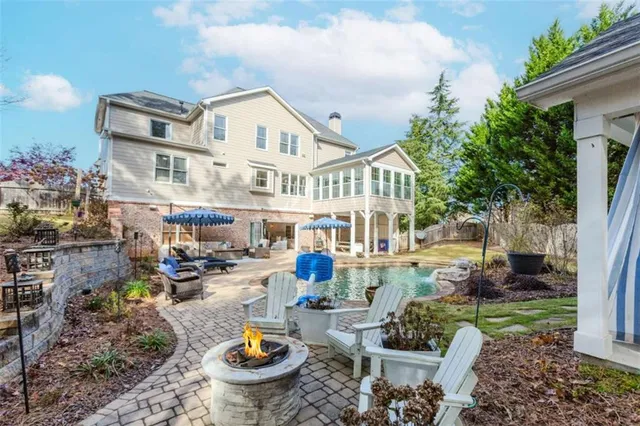 a front view of a house with garden and sitting area