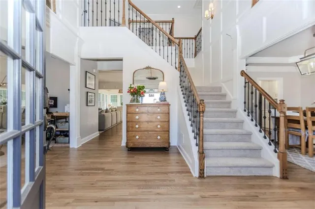 a view of entryway and hall with wooden floor