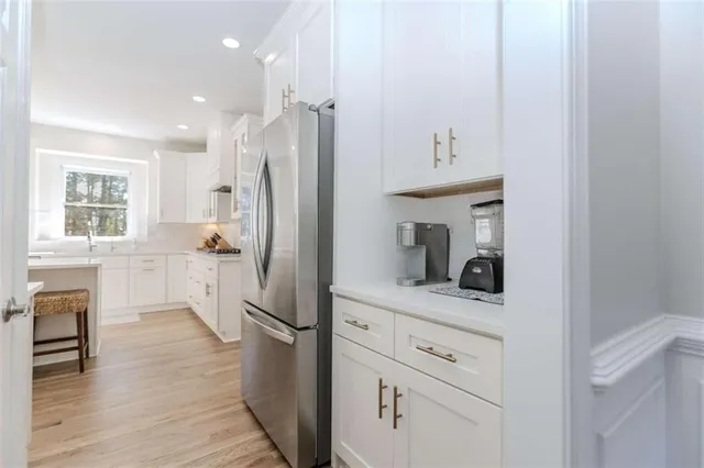 a kitchen with a refrigerator and a sink