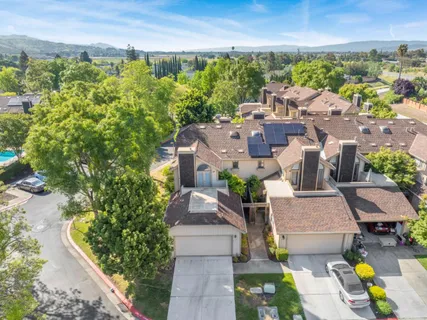 an aerial view of a house with a yard basket ball court and outdoor seating