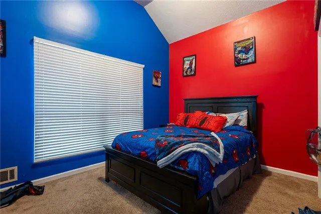 a bedroom with a bed and a tv in it