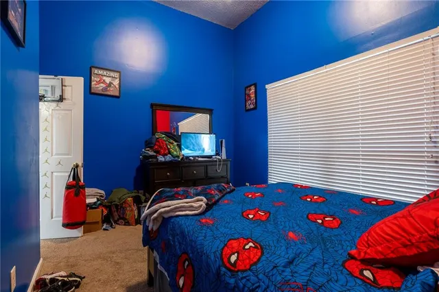 a bedroom with a bed and dresser