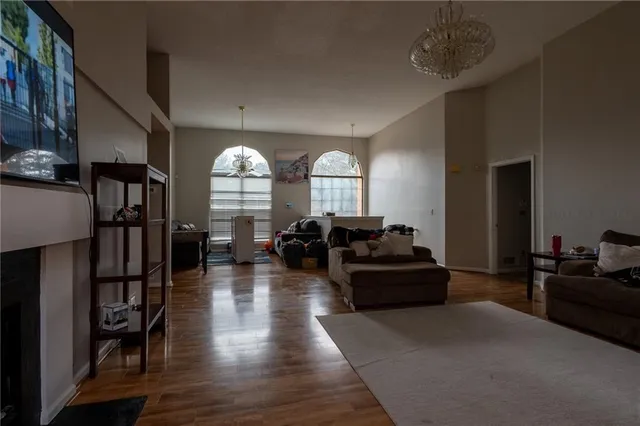 a living room with furniture fireplace and wooden floor