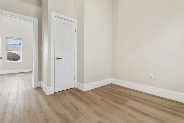 a view of a room with wooden floor