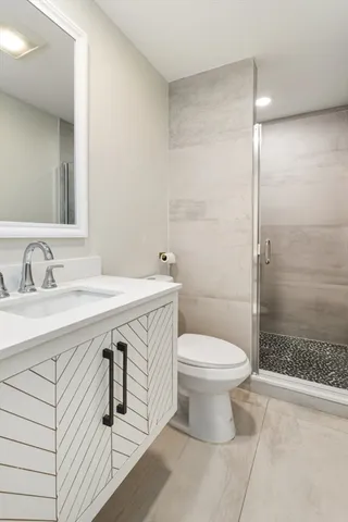 a bathroom with a sink toilet and shower