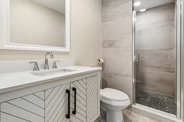 a bathroom with a sink toilet and shower