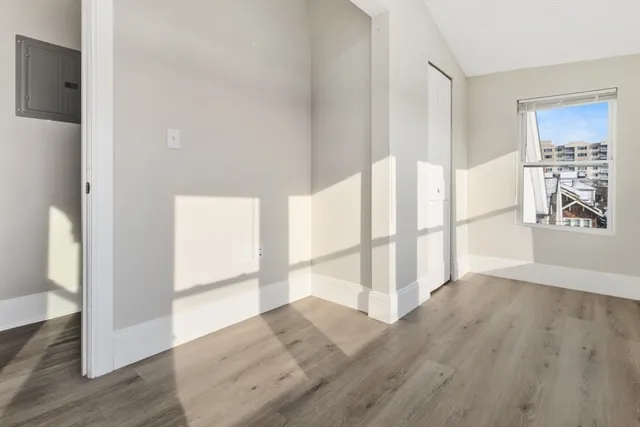 wooden floor in an empty room with a window