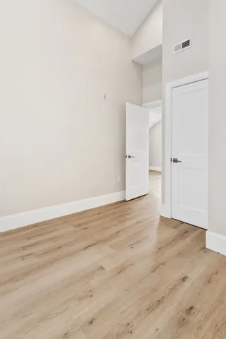 an empty room with wooden floor