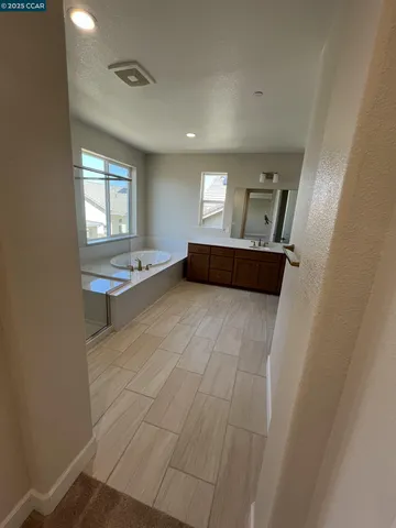 a spacious bathroom with a granite countertop sink and a mirror