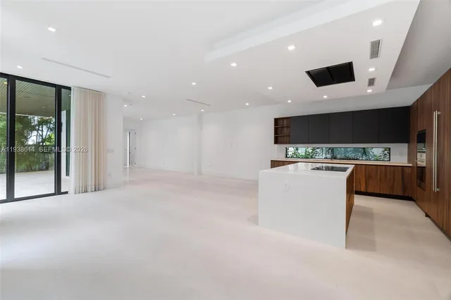 a view of kitchen with microwave and refrigerator