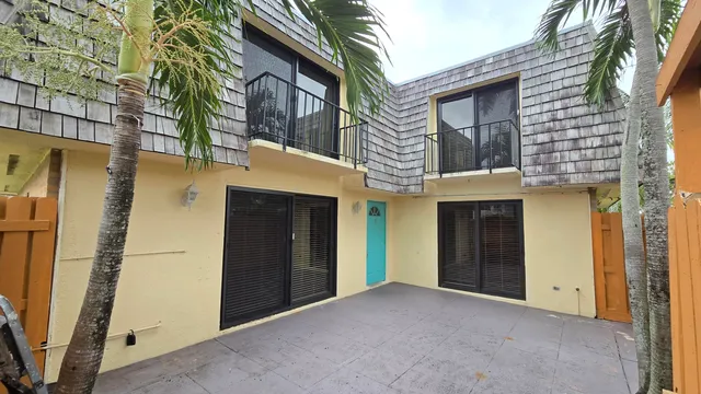 a view of a house with a door and wooden walls
