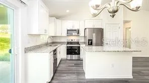 a kitchen with stainless steel appliances granite countertop a stove and a refrigerator