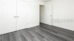 a view of wooden floor and white walls