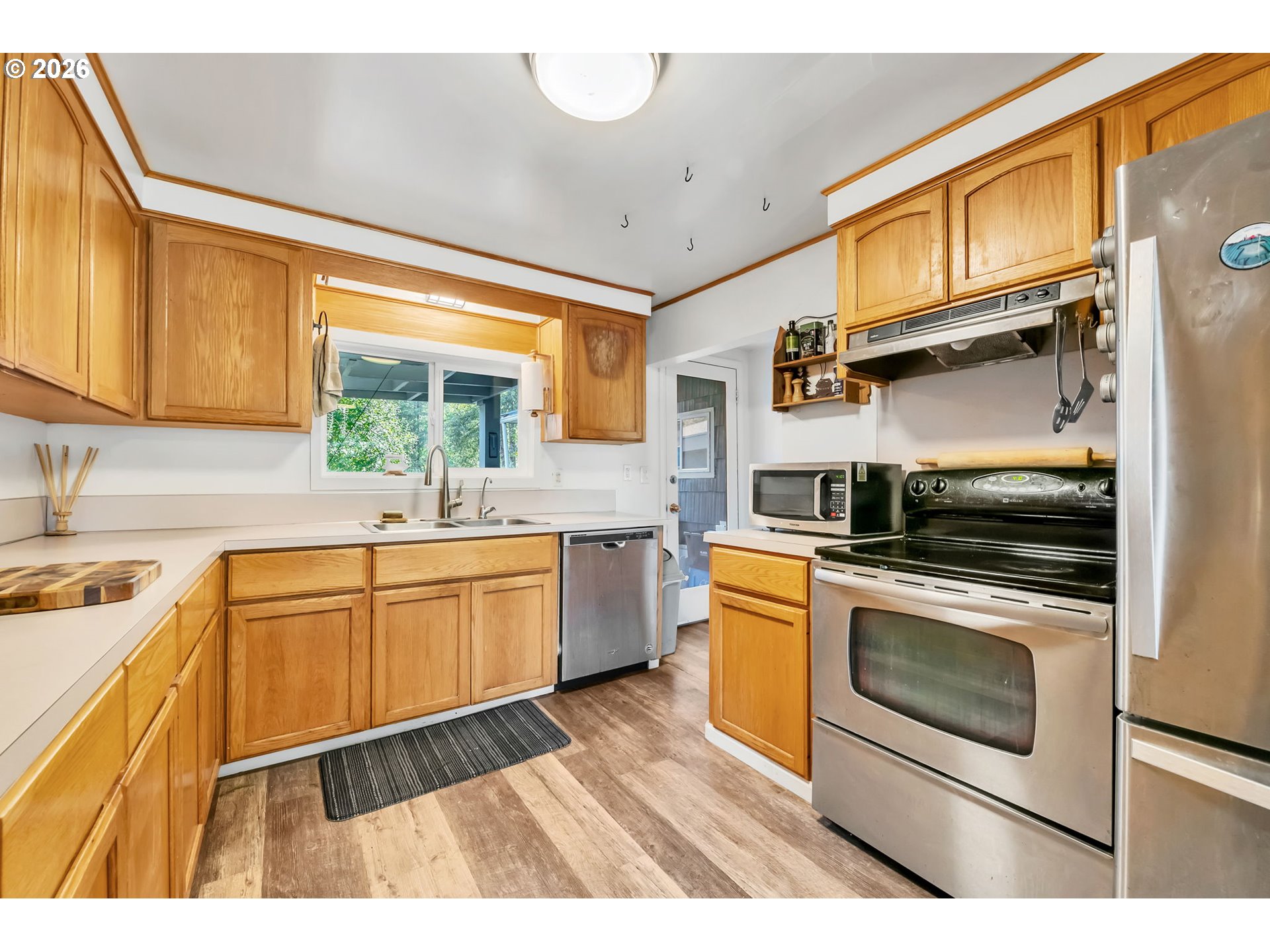 47576 Riverview Street Oakridge, OR 97463 - Photo 14 of 48 a kitchen with granite countertop a stove a sink and a refrigerator