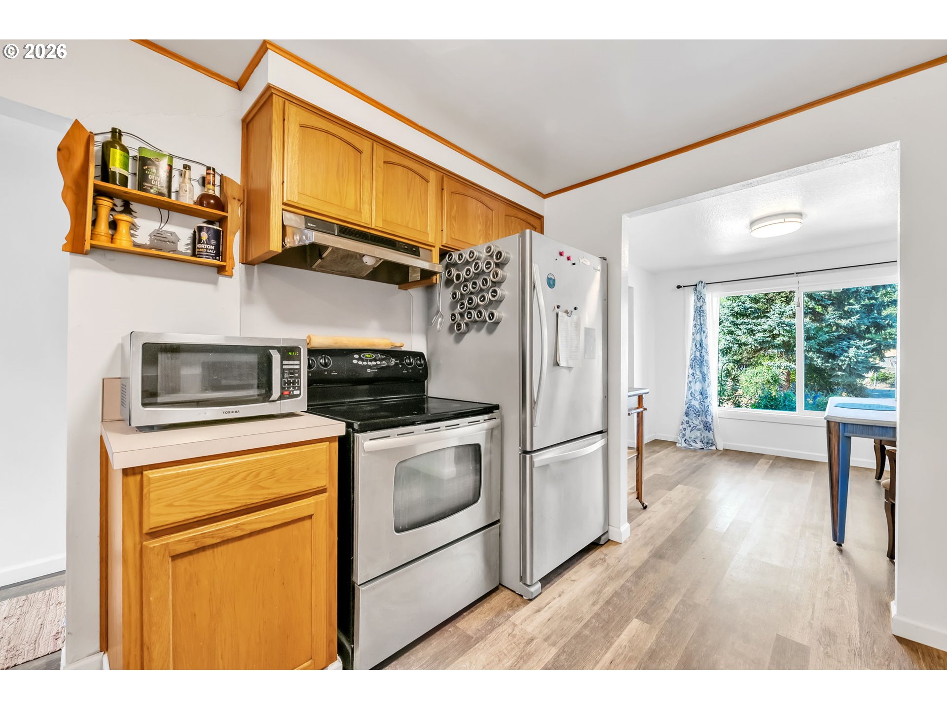 47576 Riverview Street Oakridge, OR 97463 - Photo 16 of 48 a kitchen with stainless steel appliances granite countertop a refrigerator a stove and a sink with cabinets