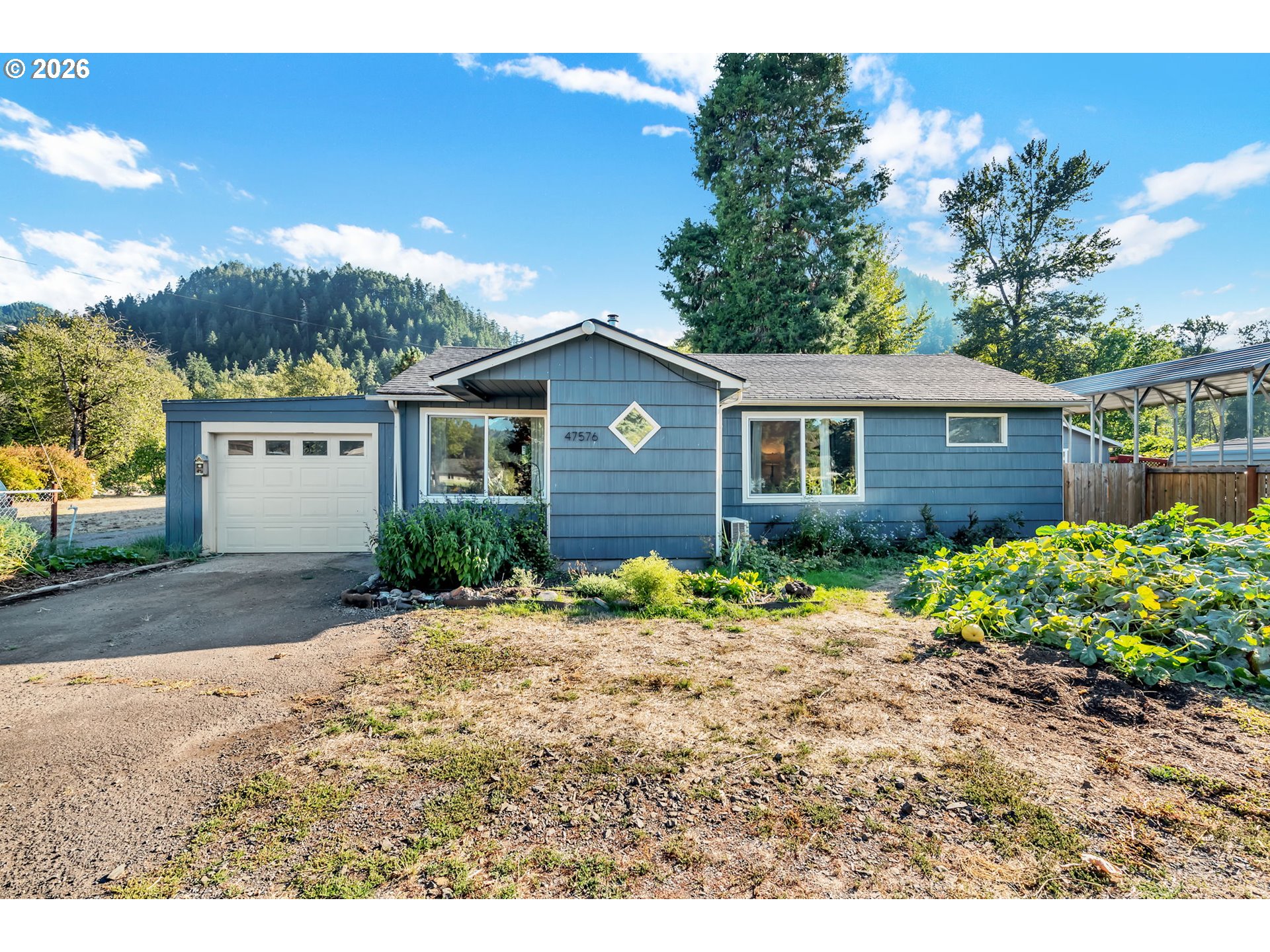 47576 Riverview Street Oakridge, OR 97463 - Photo 2 of 48 a view of a house with a yard and potted plants