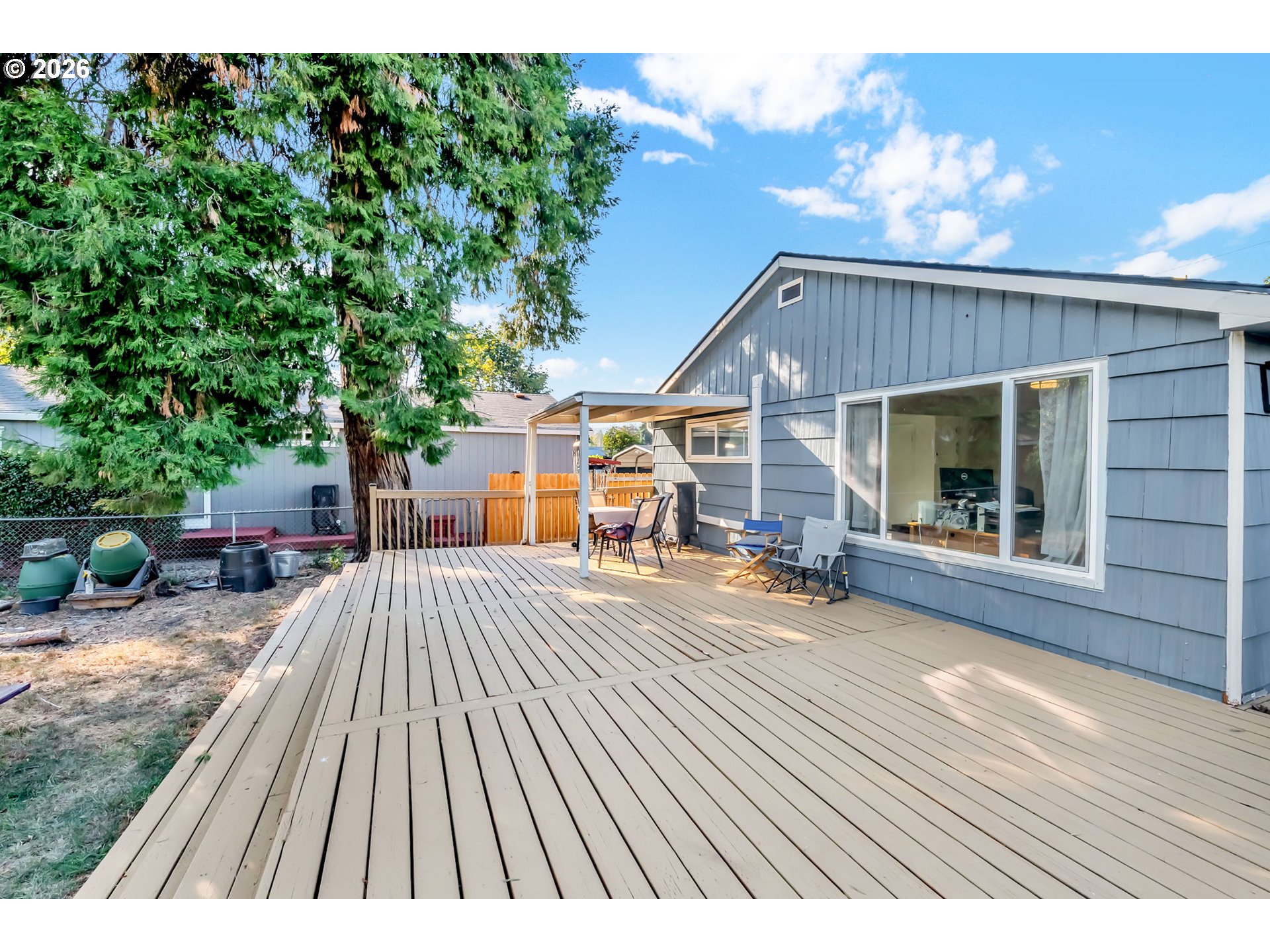 47576 Riverview Street Oakridge, OR 97463 - Photo 34 of 48 a view of a house with backyard sitting area and a garden
