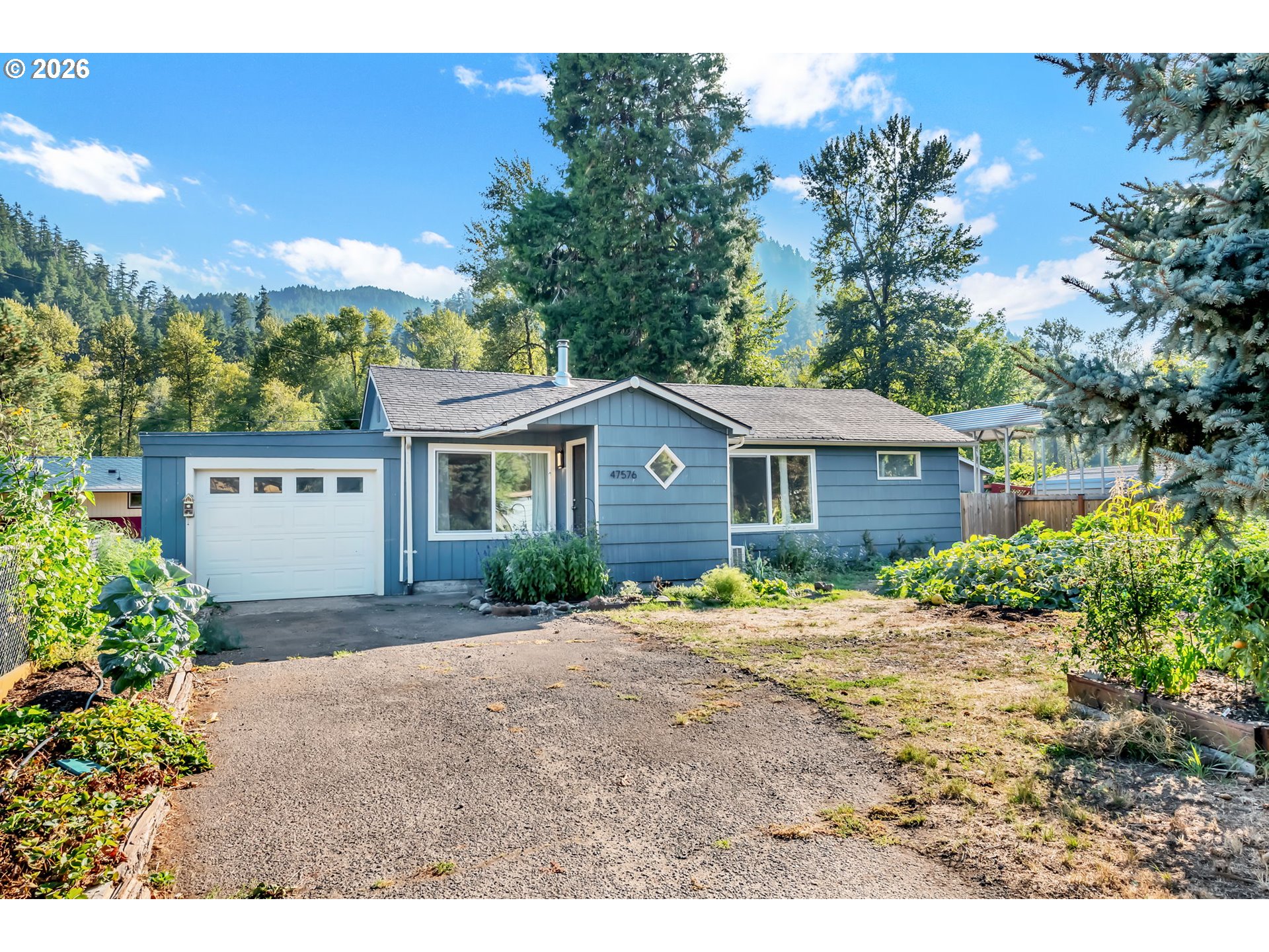47576 Riverview Street Oakridge, OR 97463 - Photo 4 of 48 a front view of a house with a garden and yard
