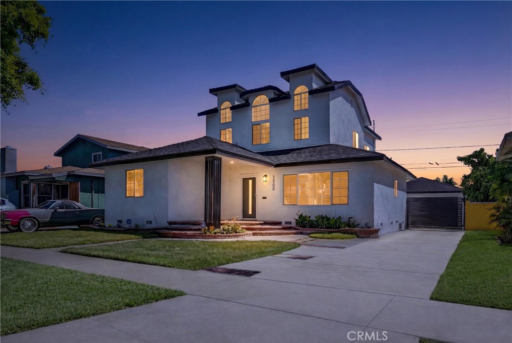 1200 South Castlegate Avenue Compton, CA 90221 - Photo 2 of 39 a front view of a house with a yard