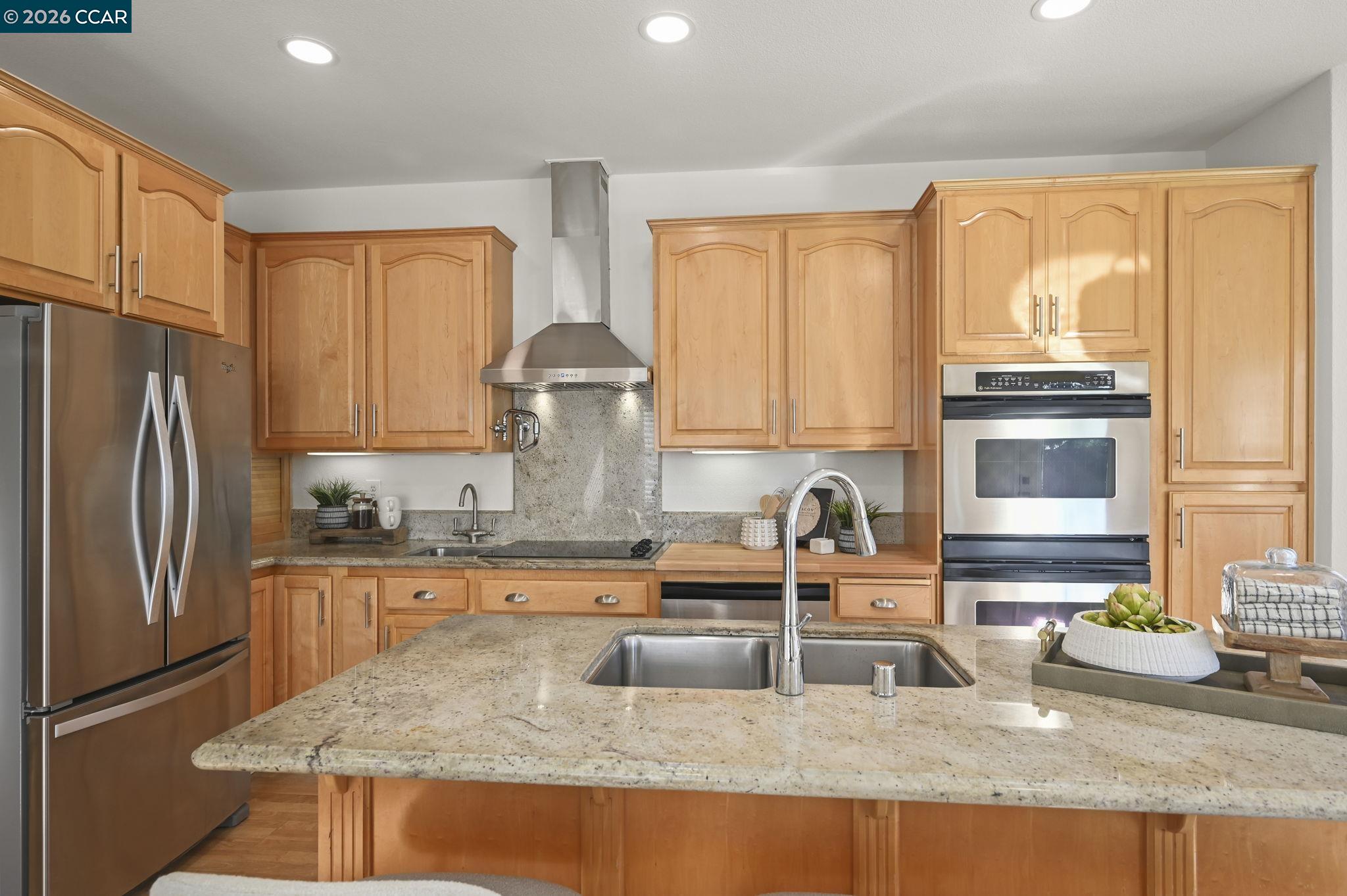 118 Neptune Place San Ramon, CA 94583 - Photo 11 of 36 a kitchen with granite countertop a sink stove and refrigerator