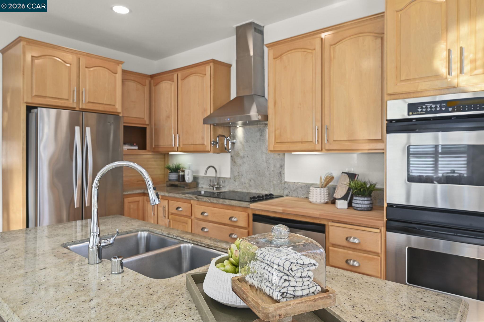 118 Neptune Place San Ramon, CA 94583 - Photo 13 of 36 a kitchen with stainless steel appliances granite countertop a sink stove and refrigerator